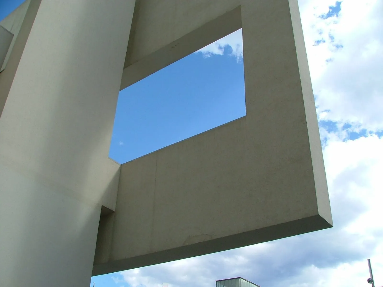 The long white exterior ramp climbing the glass facade of MACBA above the open square of Plaça dels Àngels